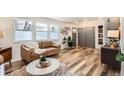Cozy living room boasts hardwood floors, stylish decor, and abundant natural light from large windows at 717 S Carr Ave, Lafayette, CO 80026
