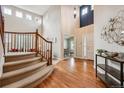 Welcoming foyer featuring wood floors, a curved staircase, and abundant natural light at 10440 Lowell Ct, Westminster, CO 80031
