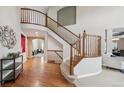 Grand foyer featuring hardwood floors, a curved staircase, and soaring ceilings at 10440 Lowell Ct, Westminster, CO 80031