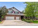 Attractive two-story home with a brick facade, three-car garage, and mature landscaping at 10440 Lowell Ct, Westminster, CO 80031