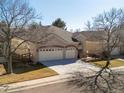 Angle view of stucco home, showing garage, front entrance, and some of the landscaping at 6700 W Dorado Dr # 42, Littleton, CO 80123