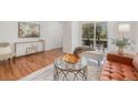 Bright living room showcasing a glass coffee table and a decorative console table and access to a balcony at 5300 E Cherry Creek South Dr # 1327, Denver, CO 80246