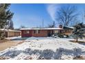 Ranch style home with a snow covered lawn at 8530 W 46Th Ave, Wheat Ridge, CO 80033