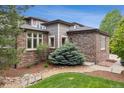 Attractive exterior features brick accents, white-framed windows, and a charming rock garden at 5334 Sedona Dr, Parker, CO 80134
