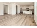 This lovely living room features neutral walls, modern floors, and views into the kitchen at 28624 E 7Th Ave, Watkins, CO 80137