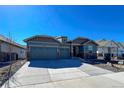 Charming home boasting great curb appeal, with a three-car garage and stone accents at 21916 E Swallow Pl, Aurora, CO 80016