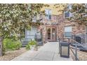 Brick building entrance with well-kept landscaping and accessible ramp at 9019 E Panorama Cir # D504, Englewood, CO 80112