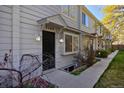 Inviting two-story townhouse featuring a well-maintained exterior, dark door, and neat landscaping at 3580 Broadway St # 3, Boulder, CO 80304
