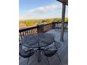 Outdoor living space on back deck with black metal table and furniture and beautiful views at 6958 Brentwood Ct, Arvada, CO 80004