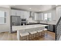 Modern kitchen with an island, stainless steel appliances, and white cabinets at 12374 Farmview St, Thornton, CO 80241