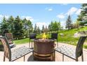 Backyard fire pit with seating in a lush green setting at 6634 Window Rock Ln, Morrison, CO 80465