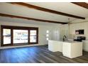 Open-concept kitchen and living room with modern cabinets and hardwood flooring at 609 S 1St Ave, Brighton, CO 80601