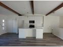 Bright kitchen featuring sleek countertops, white cabinets, and hardwood flooring at 609 S 1St Ave, Brighton, CO 80601