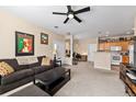 Spacious living room open to the kitchen, with a ceiling fan and ample natural light at 4084 S Crystal Cir # 104, Aurora, CO 80014