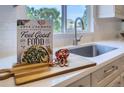 Bright kitchen sink area with book decor, light countertops, and a modern faucet at 3525 Rinn Valley Dr, Longmont, CO 80504