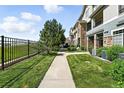 Beautiful condo exterior with manicured lawn and sidewalk access, offering a welcoming and well-maintained appearance at 474 Black Feather Loop # 406, Castle Rock, CO 80104