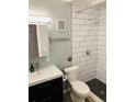 Bathroom features a modern sink and vanity, toilet, and tiled shower with a shower head at 1040 Stuart St, Denver, CO 80204