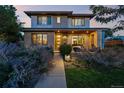Charming two-story home with landscaped front yard and inviting covered porch area at 2658 Wolff St, Denver, CO 80212