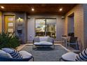 Inviting covered porch features an outdoor seating area with stylish furniture and decor at 2658 Wolff St, Denver, CO 80212