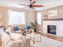 Elegant living room with a fireplace, plush seating, and ample natural light at 3472 Harvard Pl, Broomfield, CO 80023