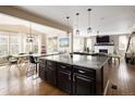 Bright living space features a large island, dining area and living room with a fireplace, ideal for entertaining and relaxation at 3472 Harvard Pl, Broomfield, CO 80023