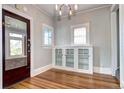 Elegant dining area featuring hardwood floors, custom built-ins, and unique windows at 2 N Pennsylvania St, Denver, CO 80203