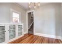Elegant dining area featuring hardwood floors, custom built-ins, and unique window at 2 N Pennsylvania St, Denver, CO 80203