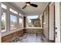 Bright sunroom with brick accents, tile floor and large windows offering street view at 2 N Pennsylvania St, Denver, CO 80203