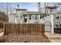 Charming townhome with a wooden fence, stone landscaping, and gated entryway at 378 Owl Dr, Louisville, CO 80027