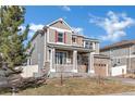 Attractive two-story home boasts a covered porch, stone accents, and professional landscaping at 12217 Skywalk St, Parker, CO 80134