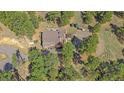 A beautiful aerial view showcases the home nestled among the trees at 24699 Us Hwy 40, Golden, CO 80401