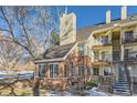 Brick townhouse exterior with landscaping and stairs at 13791 E Lehigh Ave # A, Aurora, CO 80014