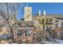 Brick townhouse exterior with stairs and landscaping at 13791 E Lehigh Ave # A, Aurora, CO 80014