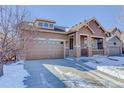 House exterior showcasing a modern design and snow on the ground at 4967 S Ukraine St, Aurora, CO 80015