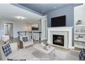 Virtually staged living room with fireplace and modern furniture at 4967 S Ukraine St, Aurora, CO 80015