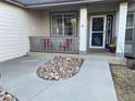 Inviting front porch with cozy seating area and stylish stone landscaping leading to the front door of this beautiful home at 2227 Chestnut Cir, Erie, CO 80516