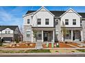 Charming townhome features a stone and white siding exterior with a covered front porch and landscaped front yard at 755 N Tibet St, Aurora, CO 80018