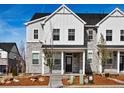 Charming townhome features a stone and white siding exterior with a covered front porch and landscaped front yard at 755 N Tibet St, Aurora, CO 80018