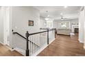 Bright entryway with hardwood floors, white wainscoting, and view into the living area at 7268 Greenwater Cir, Castle Rock, CO 80108