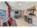 Bright living room with a modern sofa, hardwood floors, and a view to the outside at 1701 Kingston St, Aurora, CO 80010