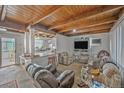 Spacious living room with a wooden ceiling, open layout and an adjacent kitchen with a breakfast bar at 1020 Kipling St, Lakewood, CO 80215