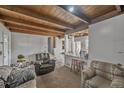 Inviting living area with wooden ceiling, an open layout concept, and kitchen bar seating at 1020 Kipling St, Lakewood, CO 80215