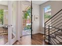 Inviting entryway featuring an open door and gleaming hardwood floors, leading to the staircase at 1703 S Grant S St, Denver, CO 80210