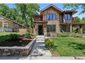 Charming stone front exterior with meticulously landscaped yard and inviting entryway at 1703 S Grant S St, Denver, CO 80210