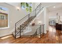 Modern staircase with metal railing and hardwood floors offer a bright and airy feel at 1703 S Grant S St, Denver, CO 80210