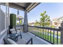 Relaxing front porch with seating, providing a tranquil outdoor space with views of the neighborhood at 21574 E 59Th Dr, Aurora, CO 80019