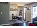 Charming dining area with hardwood floors, a table set for four, and decorative wall art at 19930 E Cornell Ave, Aurora, CO 80013