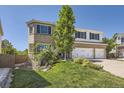 Landscaped front yard of the two-story brick home with a three-car garage and a view of mature trees at 2950 Wyecliff Ln, Highlands Ranch, CO 80126