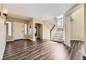 Inviting living room features hardwood floors and staircase to second level at 2950 Wyecliff Ln, Highlands Ranch, CO 80126