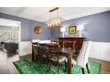 The dining room has stylish lighting and a large wooden table, perfect for hosting gatherings and meals at 6869 S Niagara Ct, Centennial, CO 80112